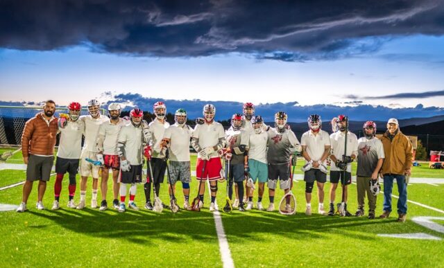 Group photo of the lacrosse team on the soccer field.