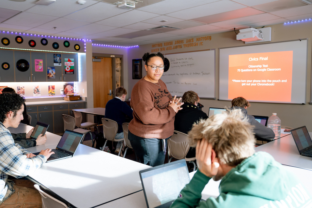 A student teacher looks over high school students