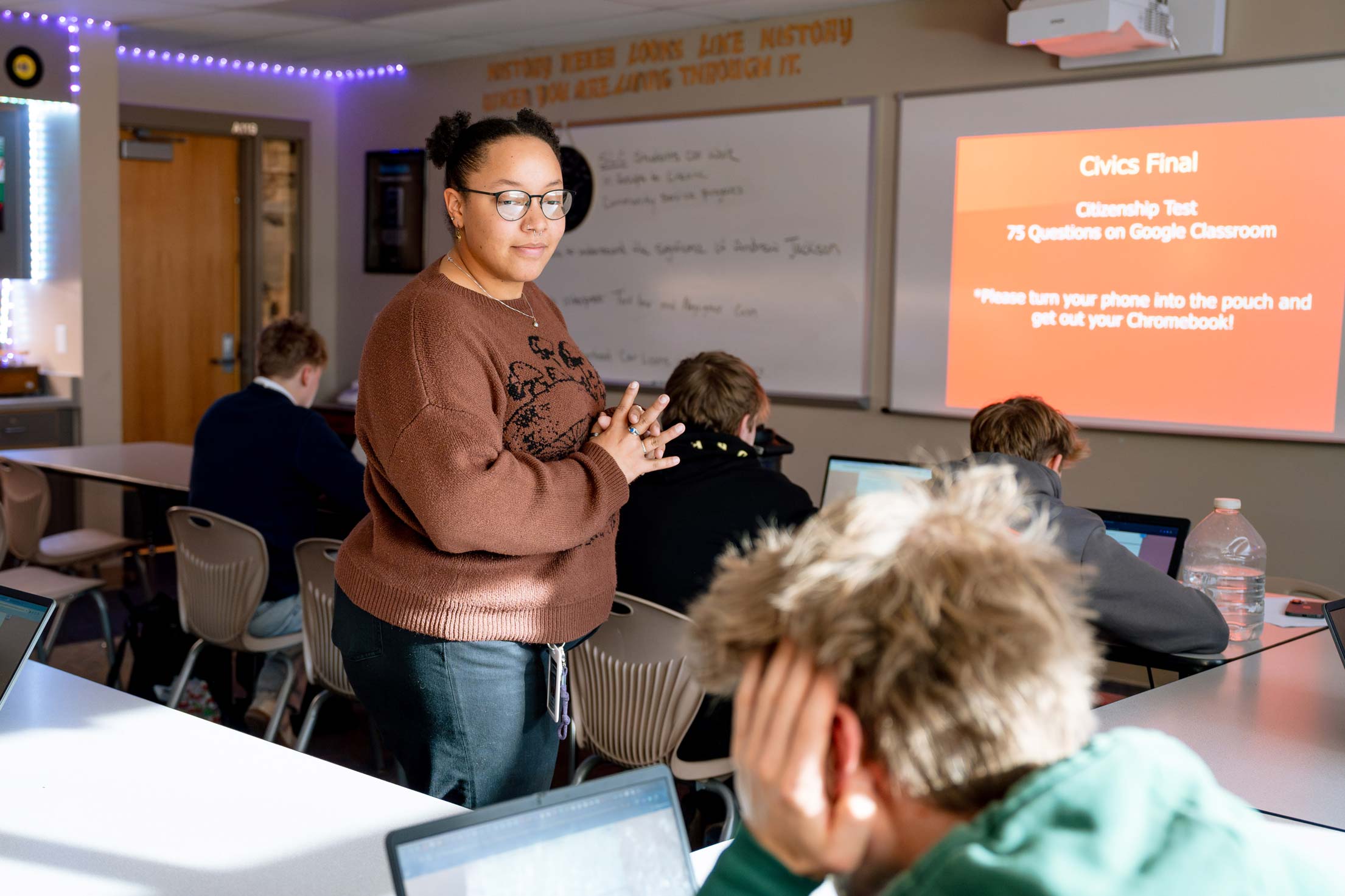 A student teacher looks over high school students.