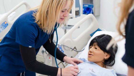 A healthcare professional uses a stethoscope to examine a patient.