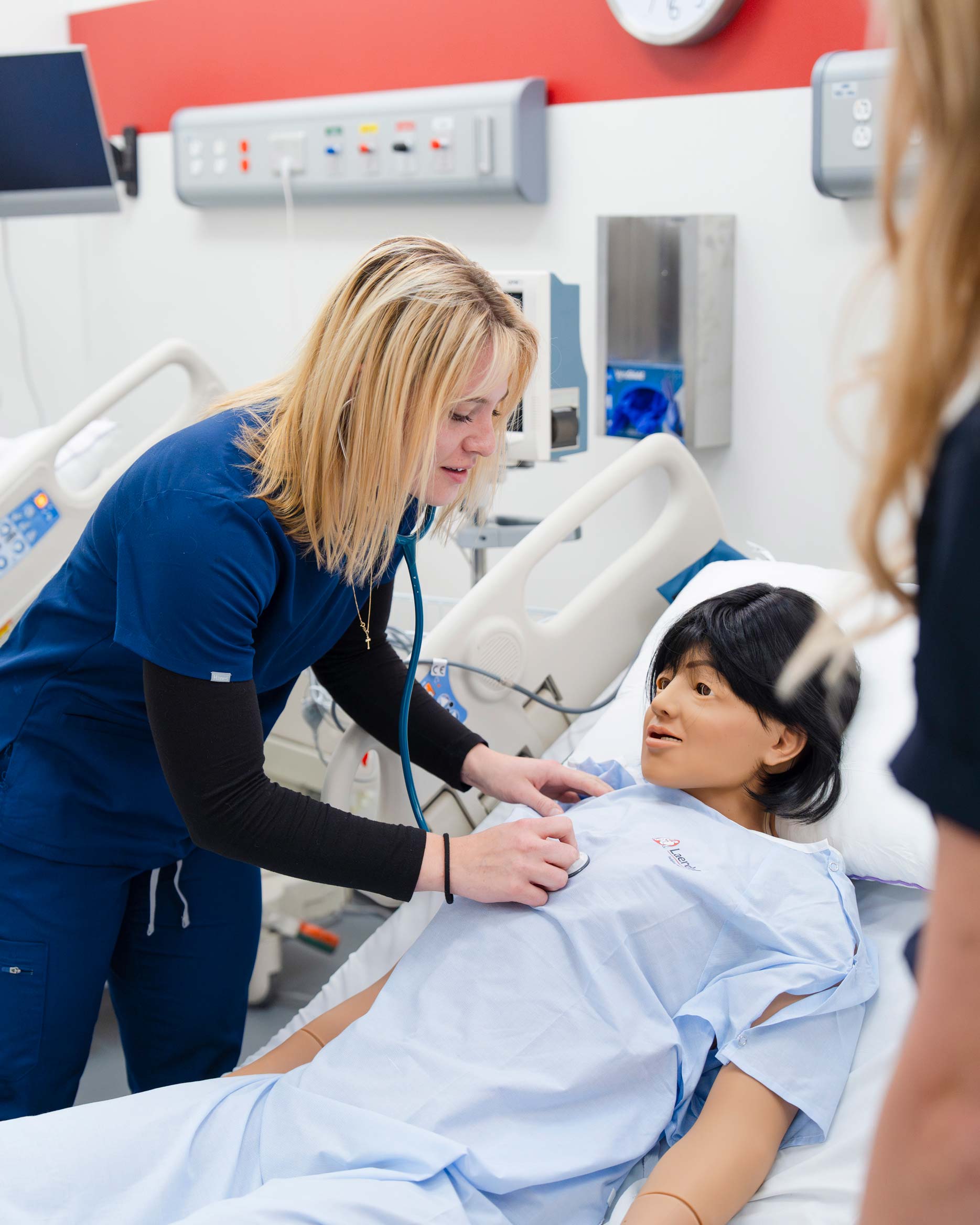 A healthcare professional uses a stethoscope to examine a patient.