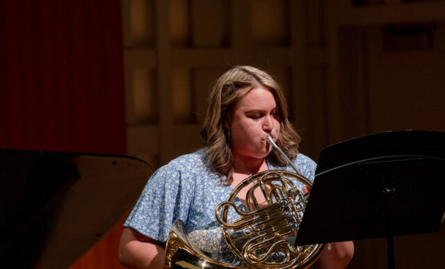 Student playing the french horn.