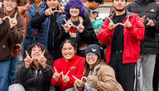 The Multicultural Center gathers for a group photo outside.