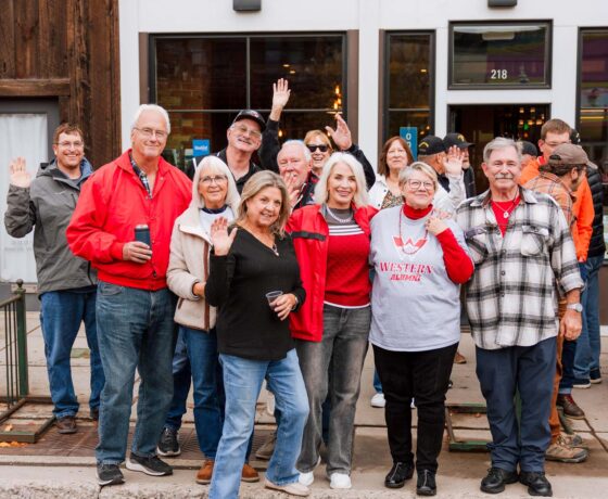 Alumni gather for a group photo on Gunnison Main Street before the Homecoming Parade.